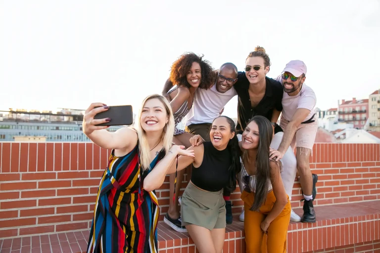group of people taking a photo with phone