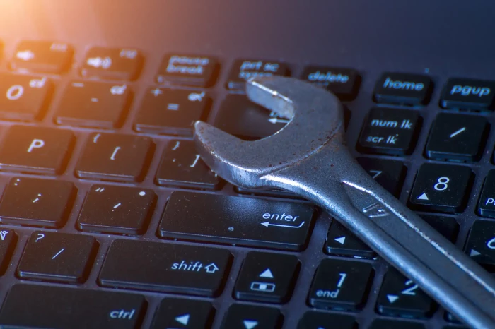 wrench on computer keys